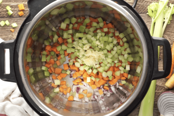 Vegetables get sauteed in the Instant Pot for vegan chili