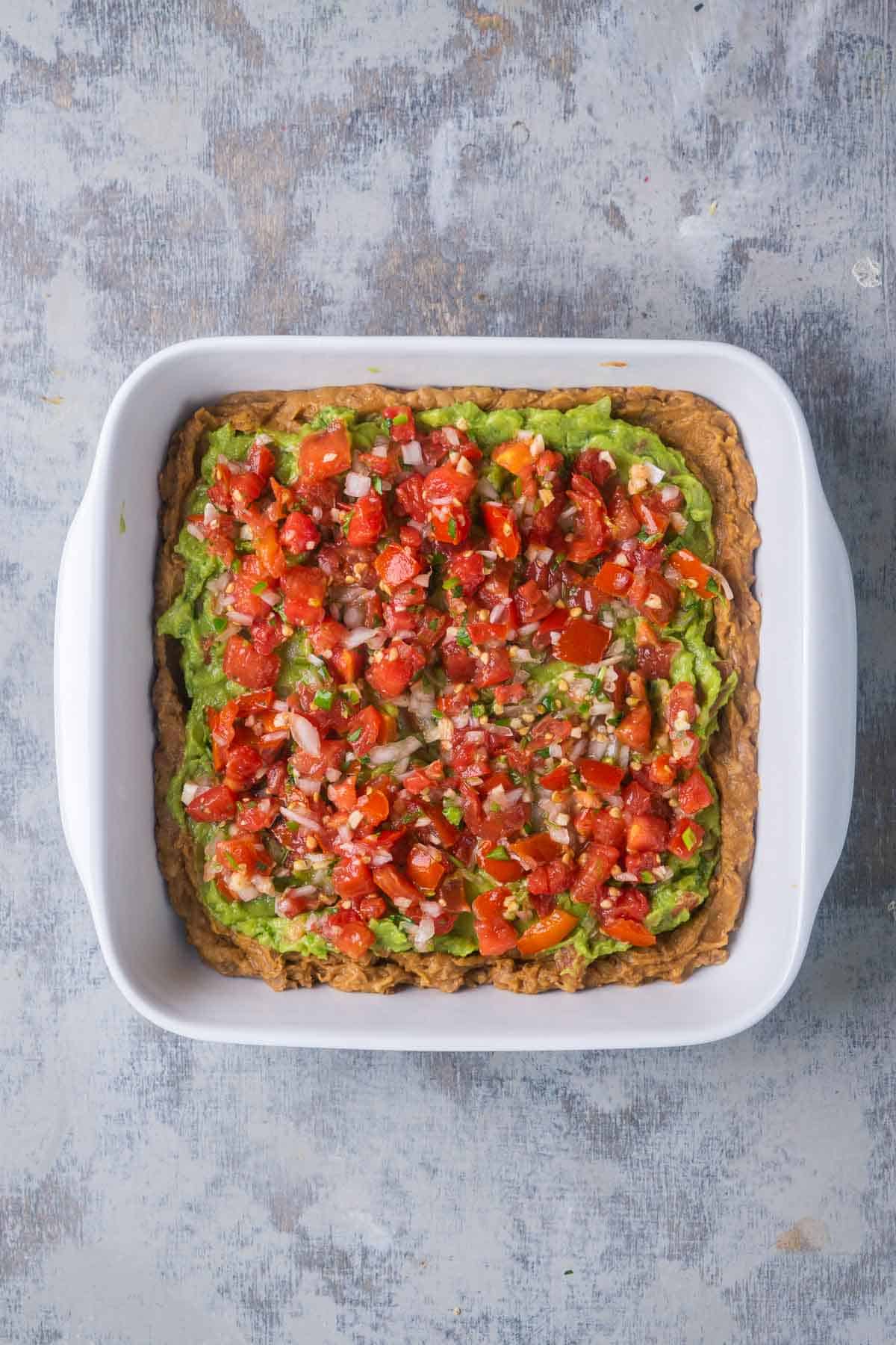 salsa layer is added to seven layer dip