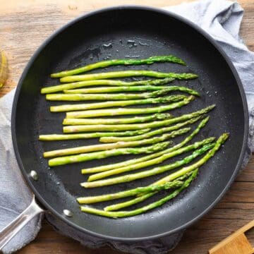 sauteed asparagus in black skillet