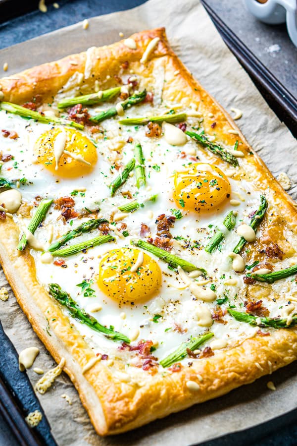 breakfast pizza puff pastry on parchment lined sheet pan