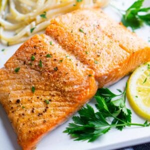 broiled salmon fillet on white plate