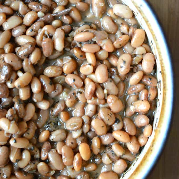 Cooked pinto beans in dutch oven on cutting board