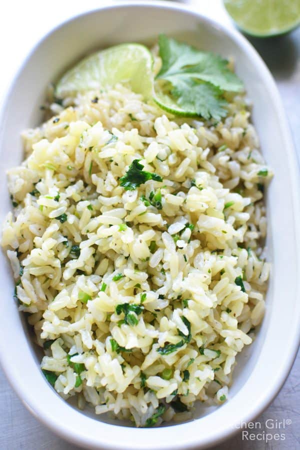 cilantro lime rice in white bowl garnished with lime and cilantro