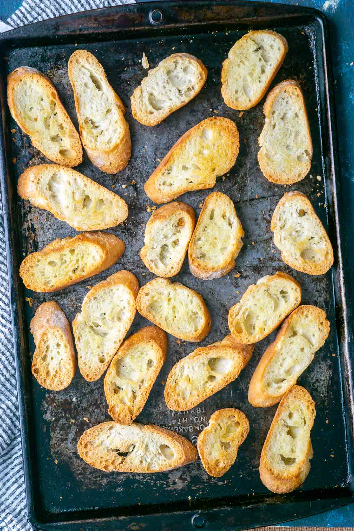 golden brown crostini on baking sheet