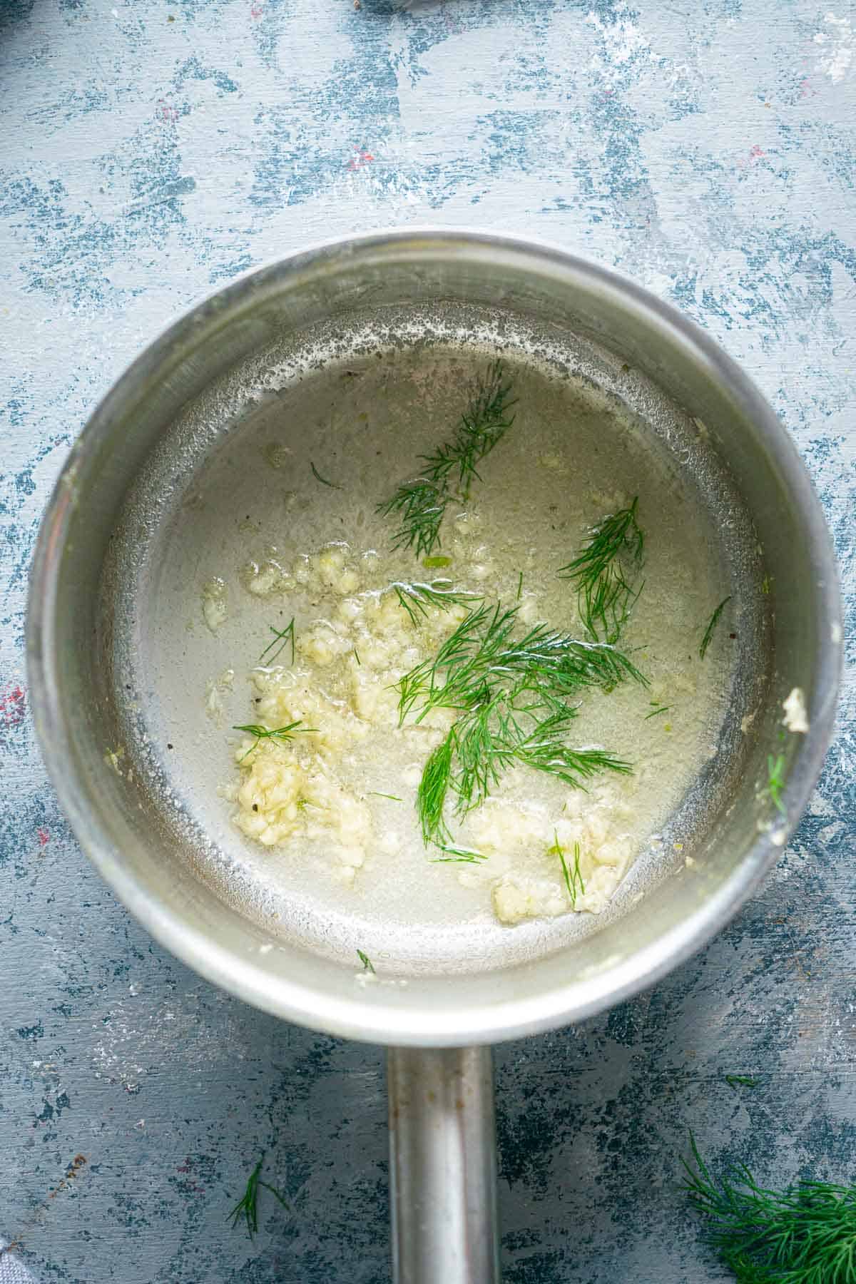 dill and garlic butter sauce in sauce pot