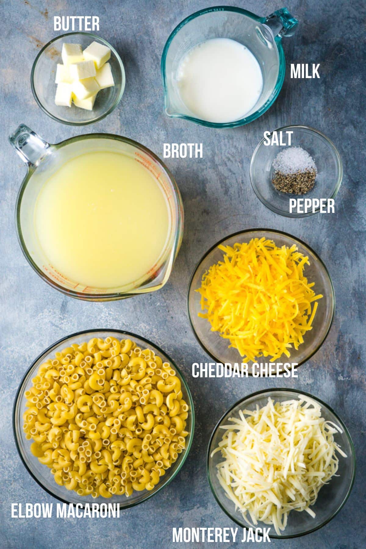 ingredients for Instant Pot mac and cheese labeled in glass bowls