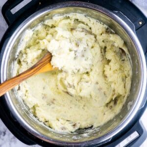mashed potatoes in Instant Pot with wood spoon