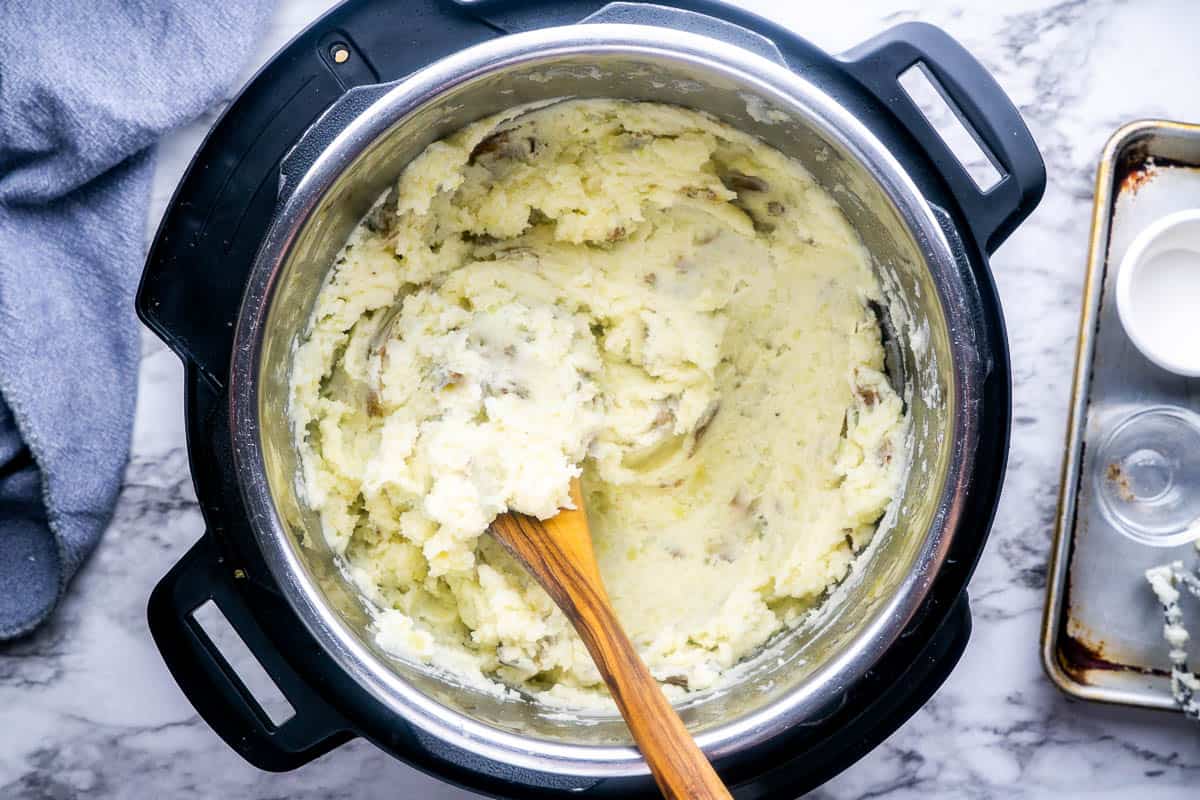 mashed potatoes in Instant Pot with wood spoon