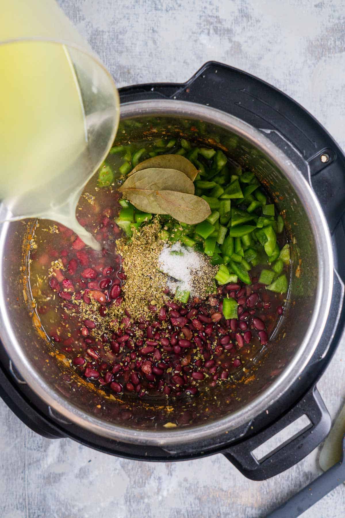 broth is added to ingredients for red beans and rice in Instant Pot