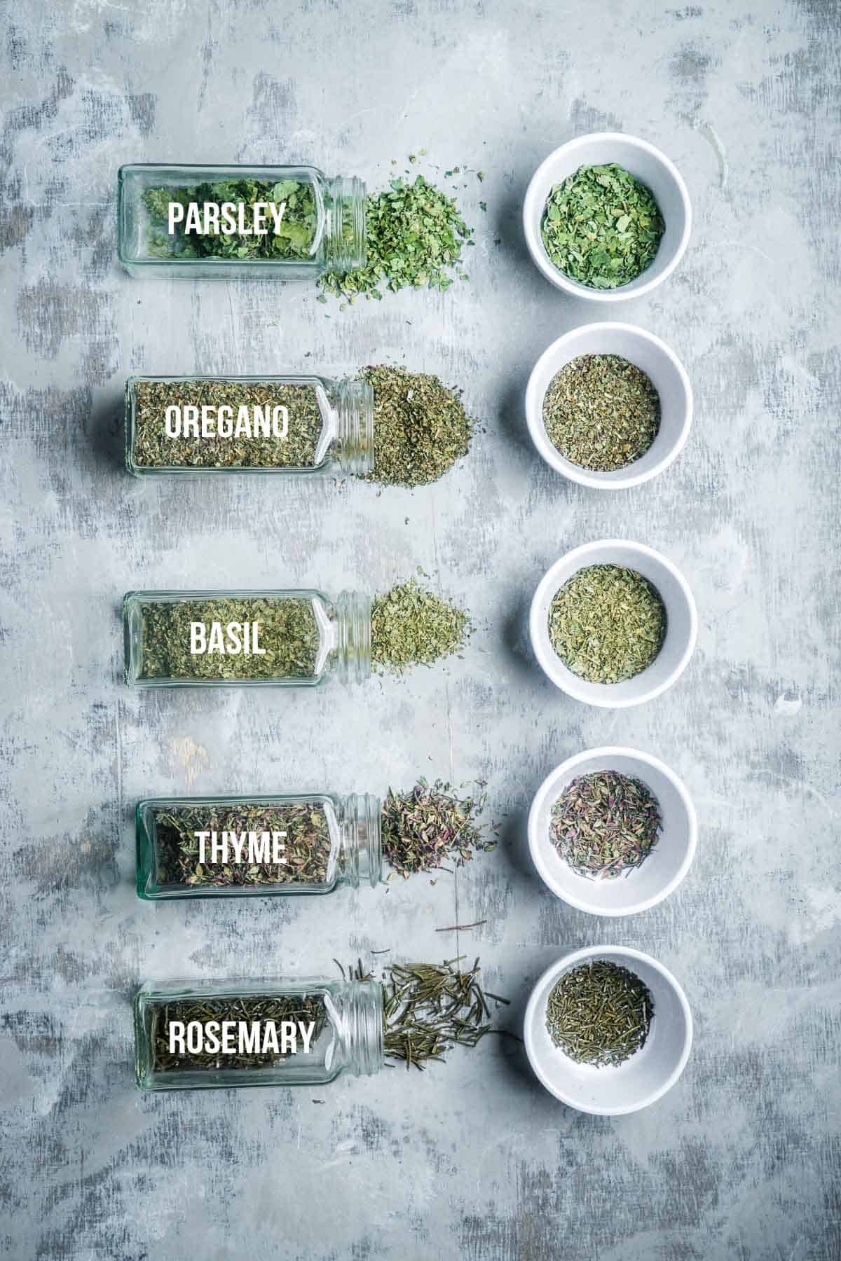 dried herbs for Italian seasoning in labeled jars and ramekins