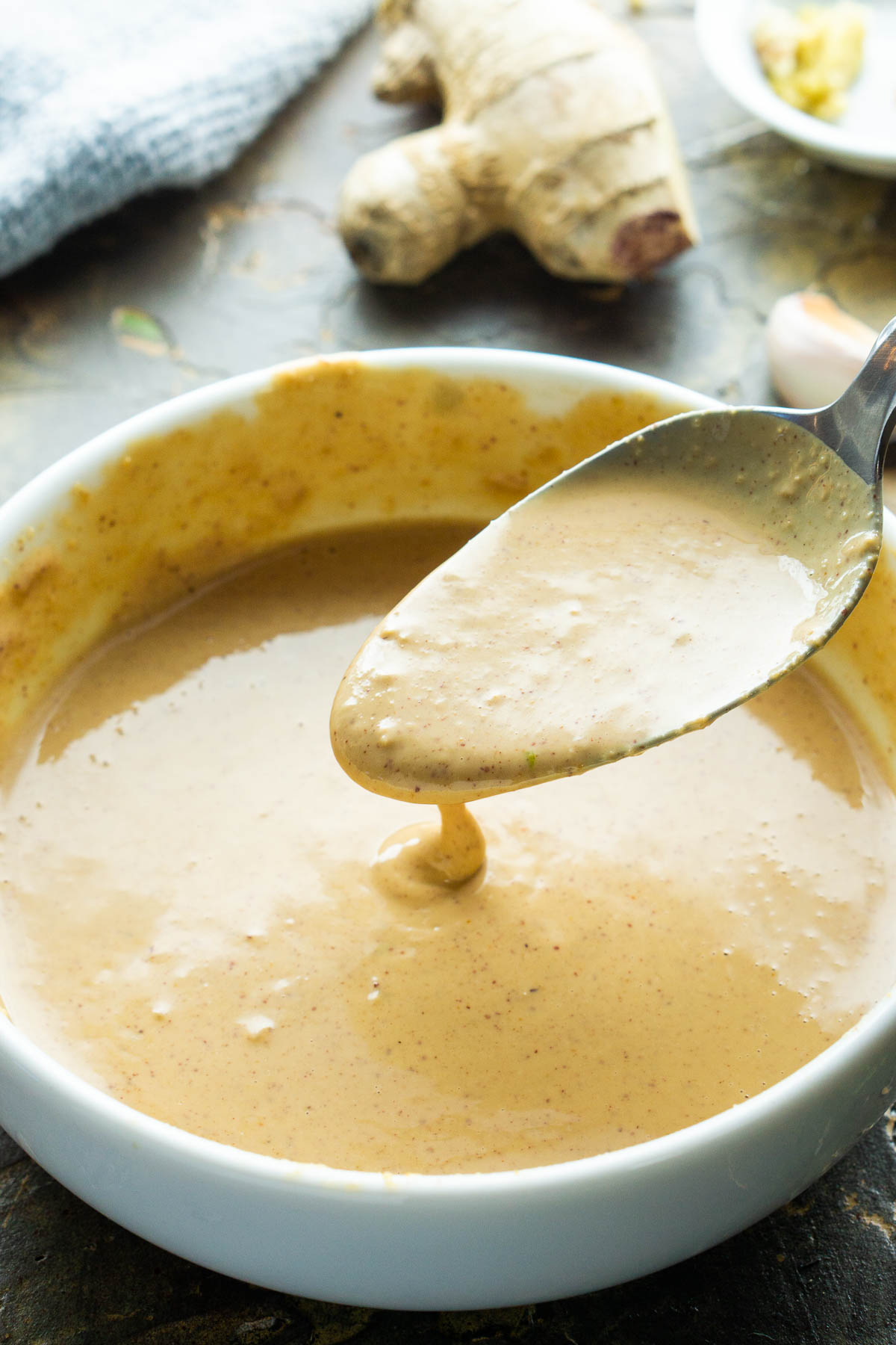 spoonful of peanut sauce in white bowl