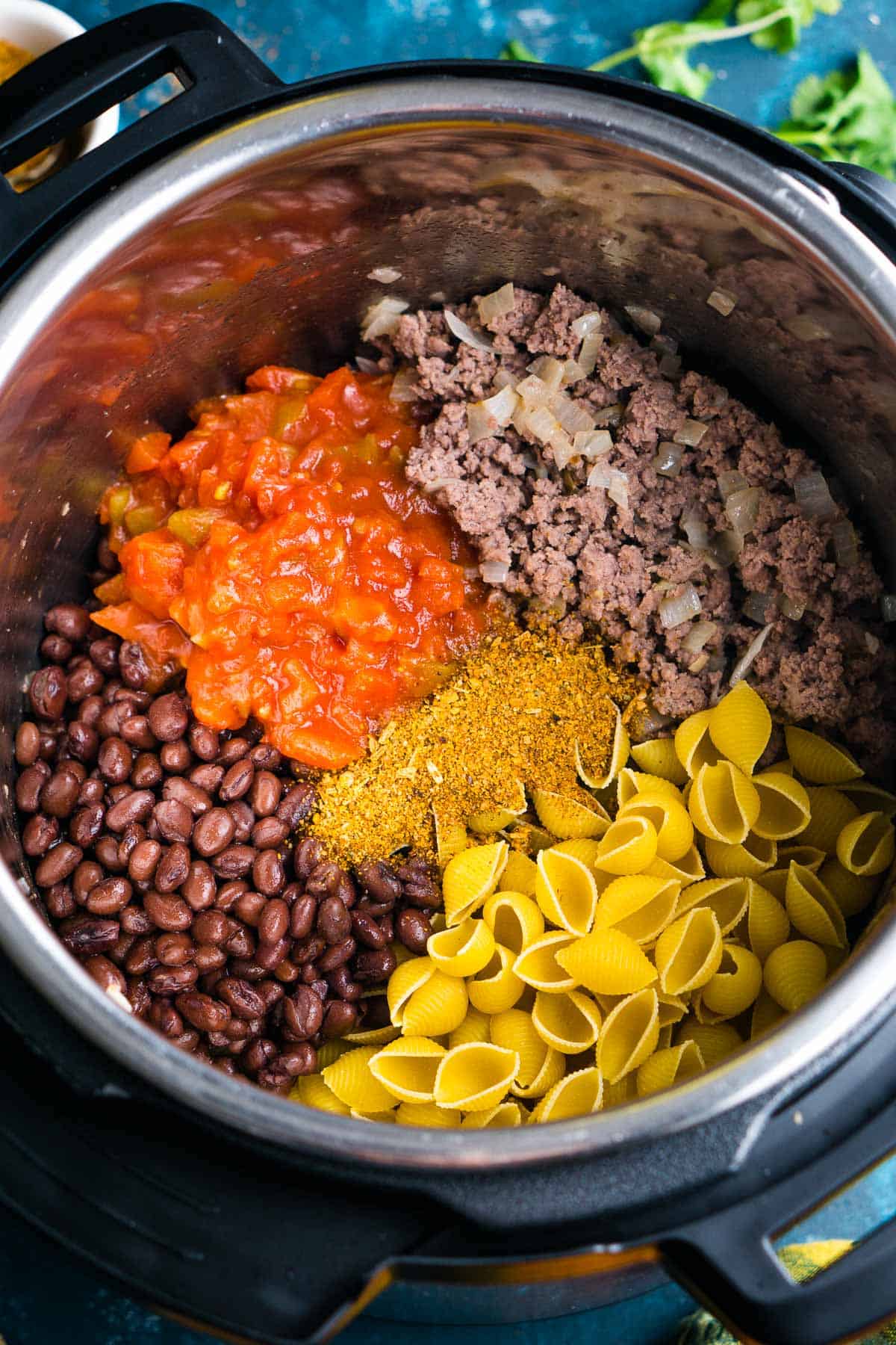 Taco pasta ingredients in the Instant Pot just before pressure cooking