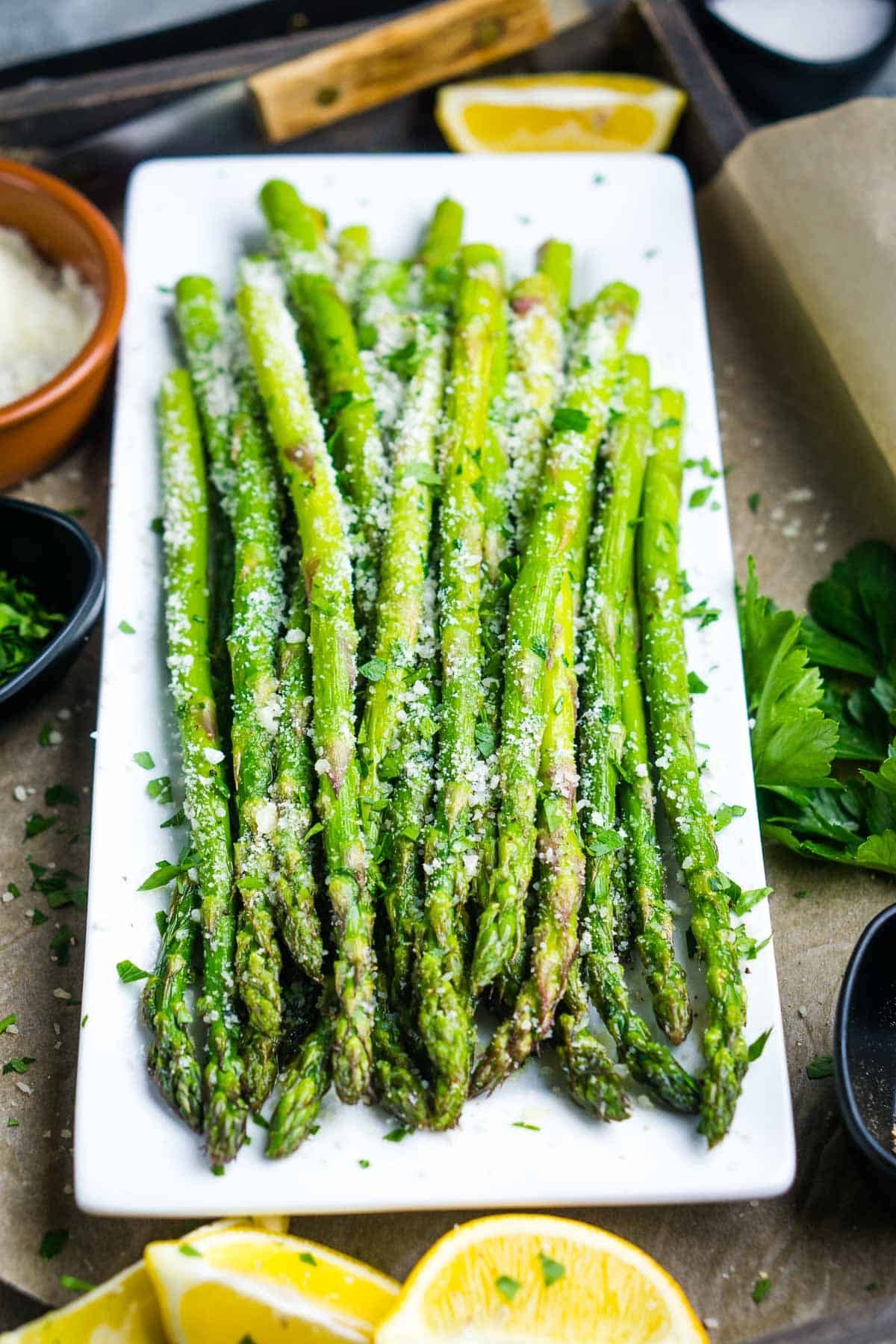 Air fryer asparagus on white rectangular serving tray