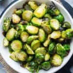 Air fried Brussels sprouts in white serving bowl
