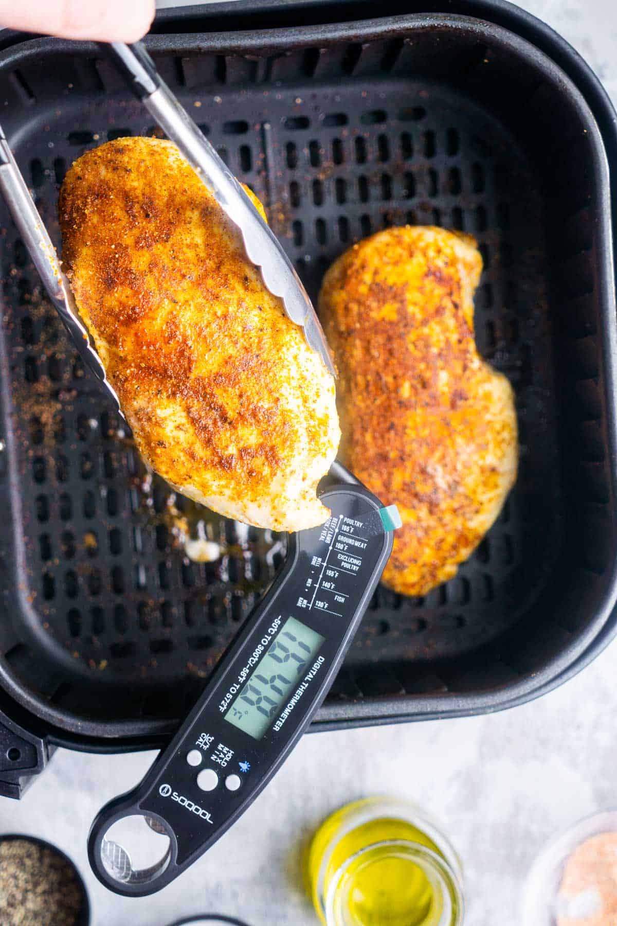 Checking the internal temperature of an air fryer chicken breast