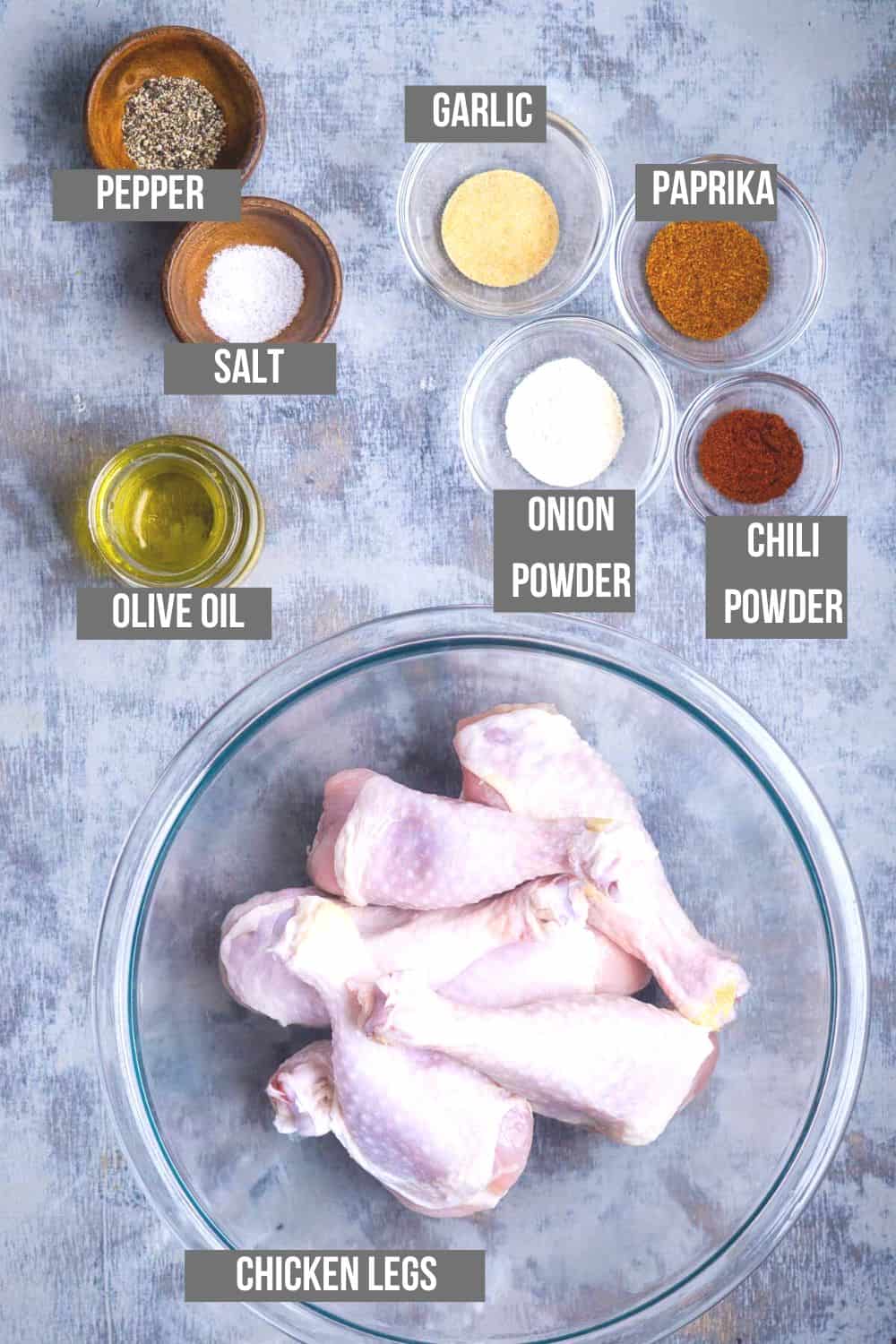 air fryer chicken legs ingredients measured into small bowls and labeled