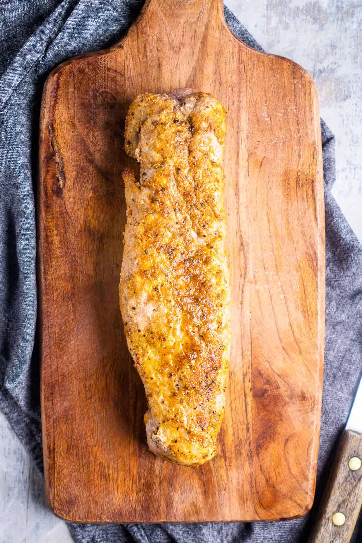 Whole pork tenderloin on cutting board