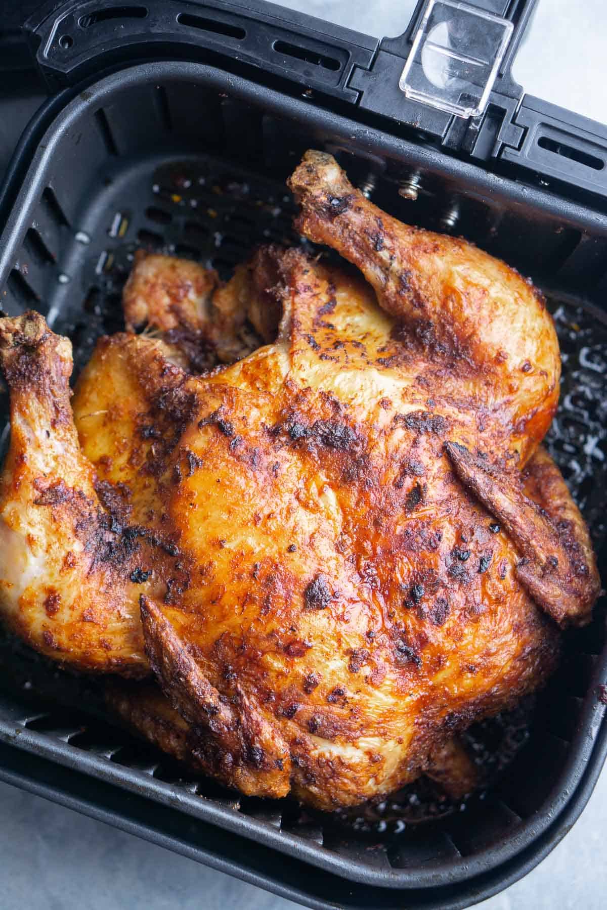 cooked whole chicken in air fryer basket