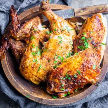 air fryer whole chicken cut into pieces in wood serving bowl