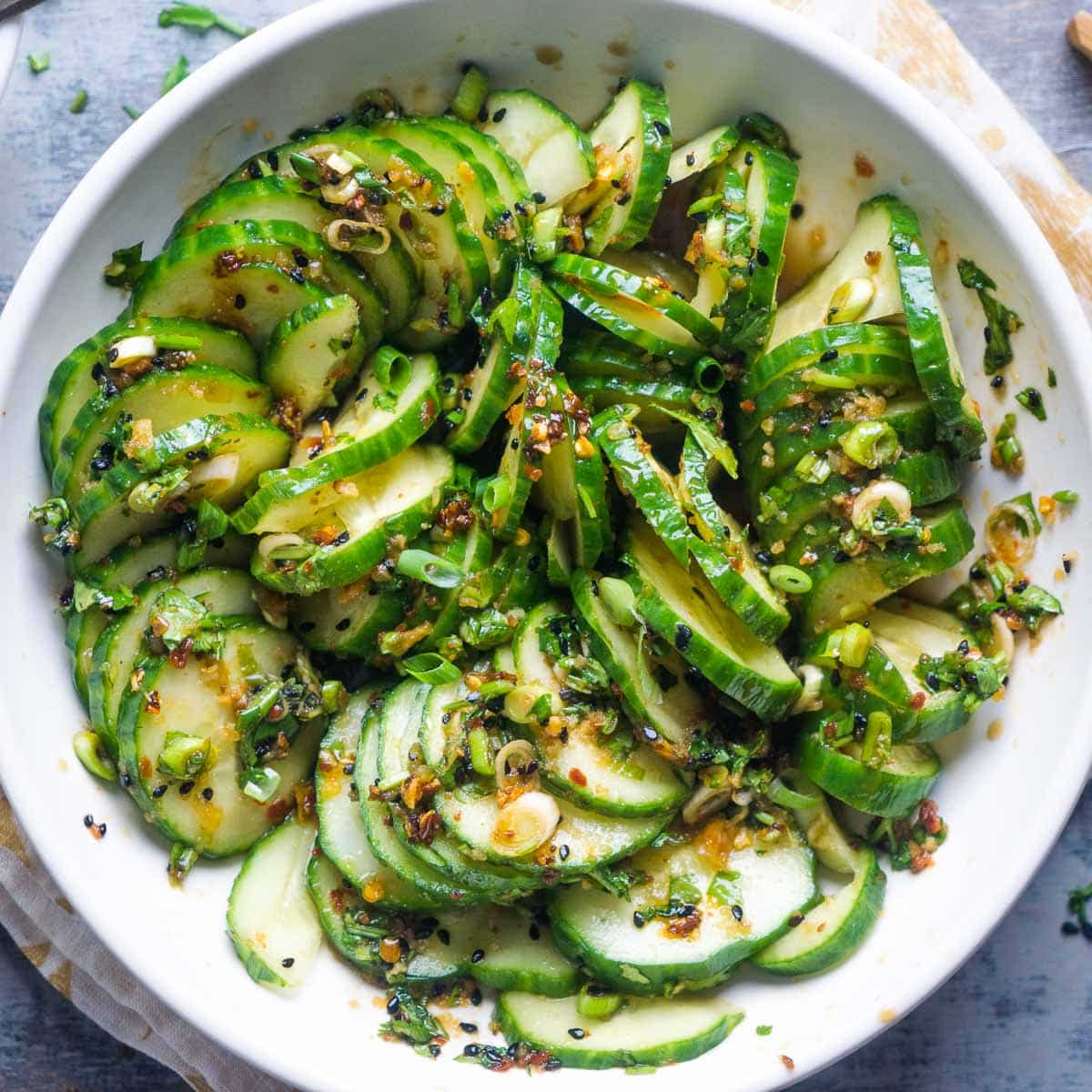 Asian cucumber salad in white bowl