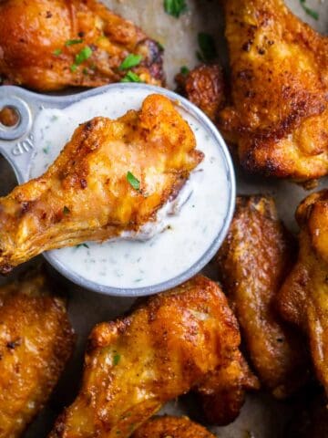crispy baked chicken wings with ranch dressing and celery sticks