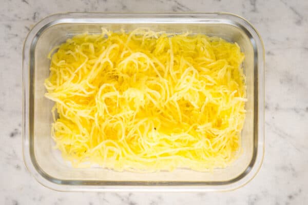 roasted spaghetti squash noodles in glass meal prep container