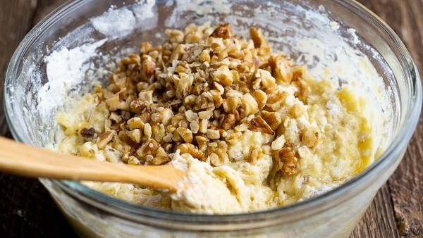 glass bowl of banana bread batter with walnuts