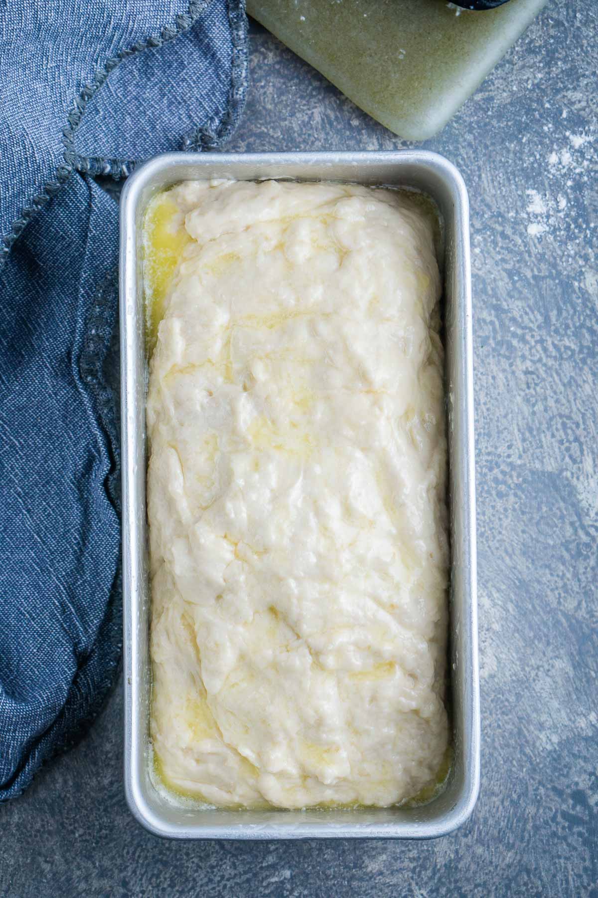 beer bread batter in loaf pan with melted butter topping
