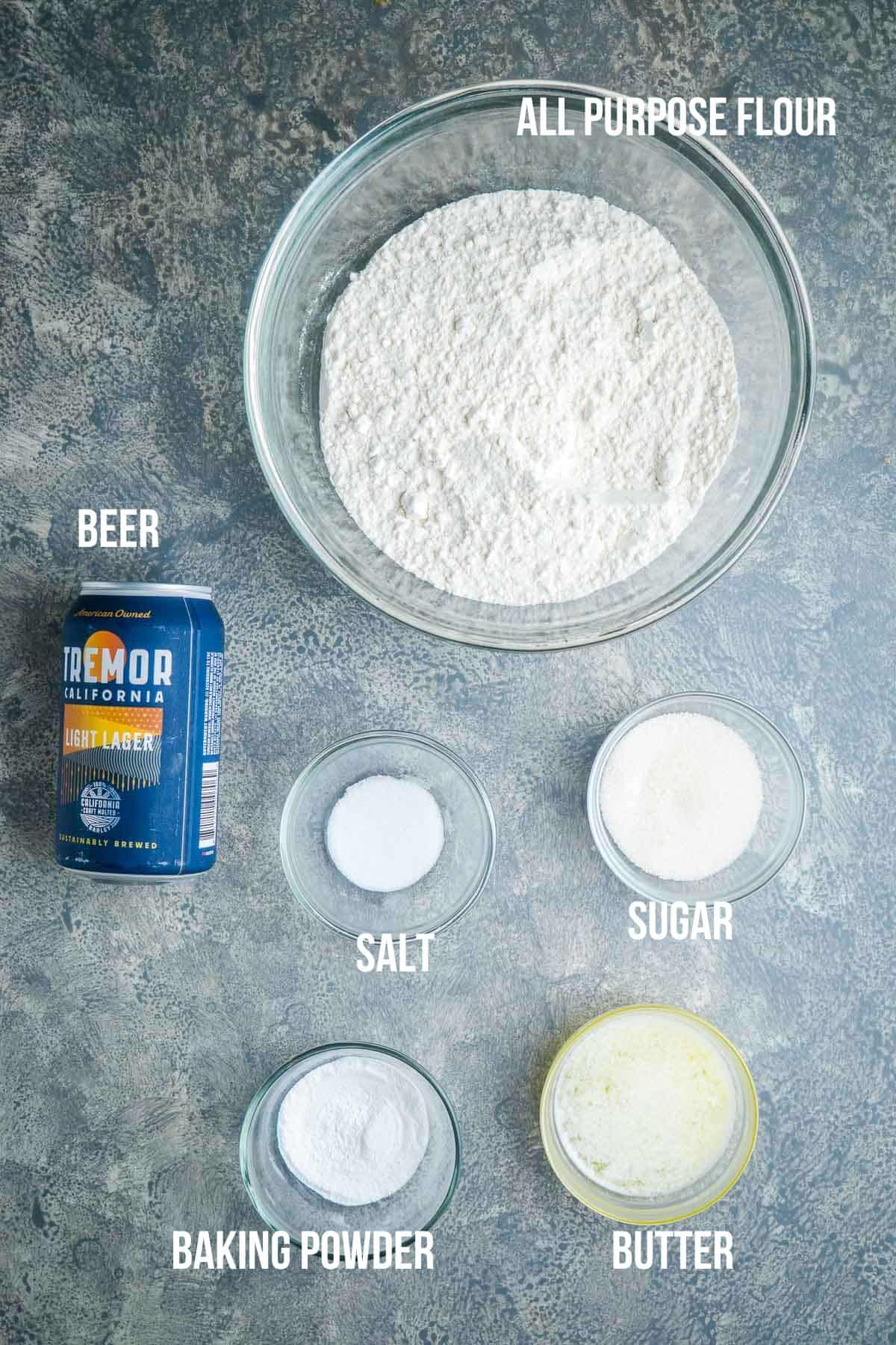 ingredients for beer bread in glass bowls lableled and ready for mixing