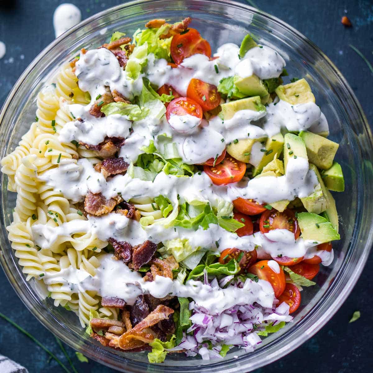 dressed BLT pasta salad in glass bowl