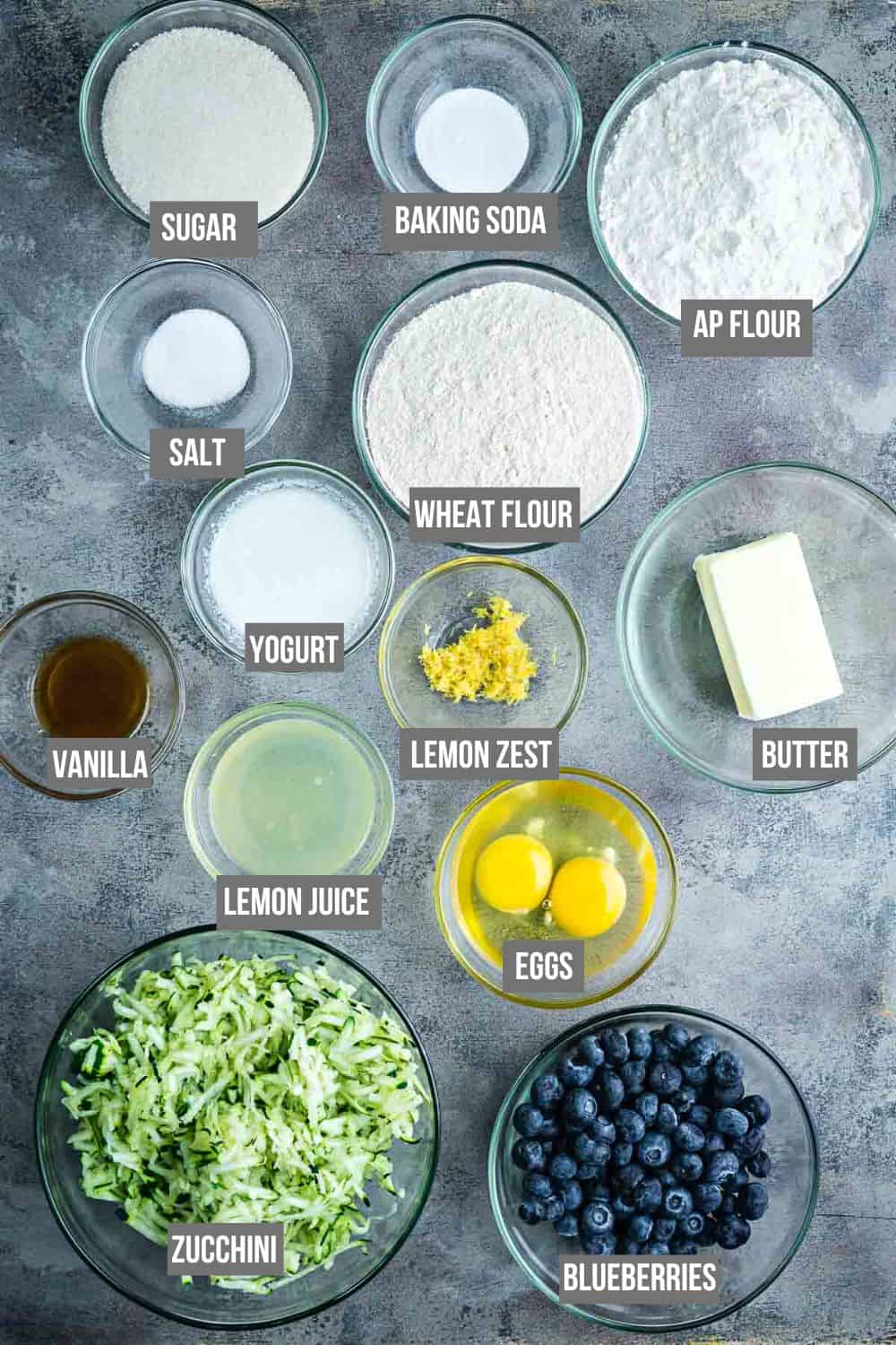 blueberry zucchini bread ingredients measured in bowls with text overlay