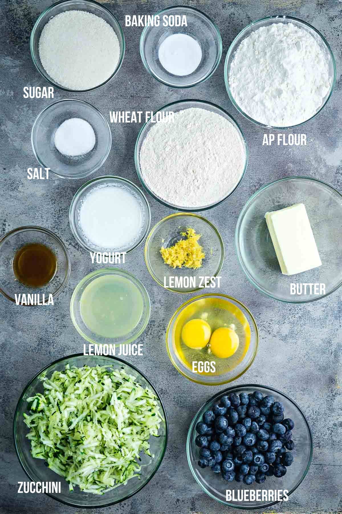 ingredients for blueberry zucchini bread measured in bowls with text overlay
