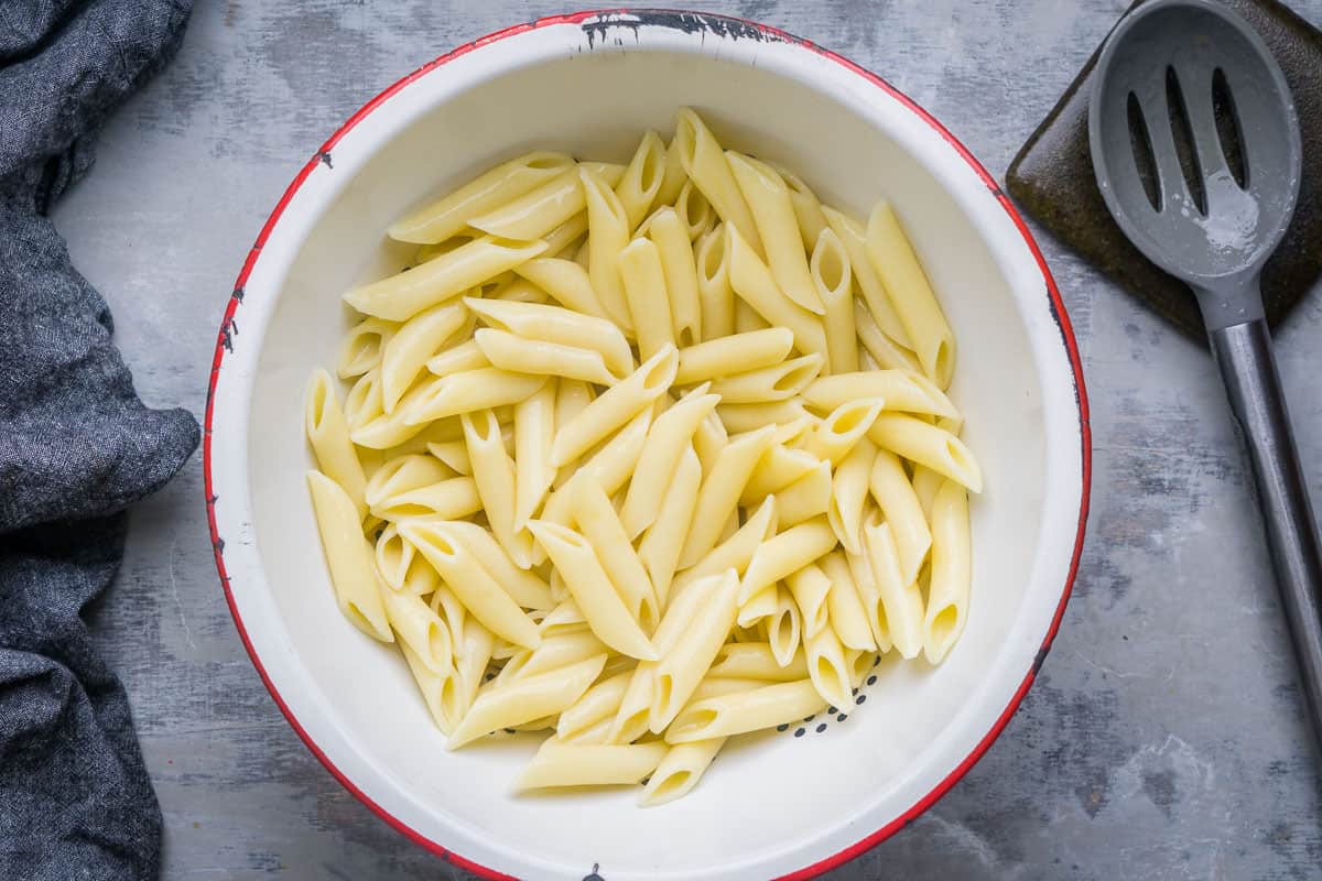 colander of cooked penne pasta
