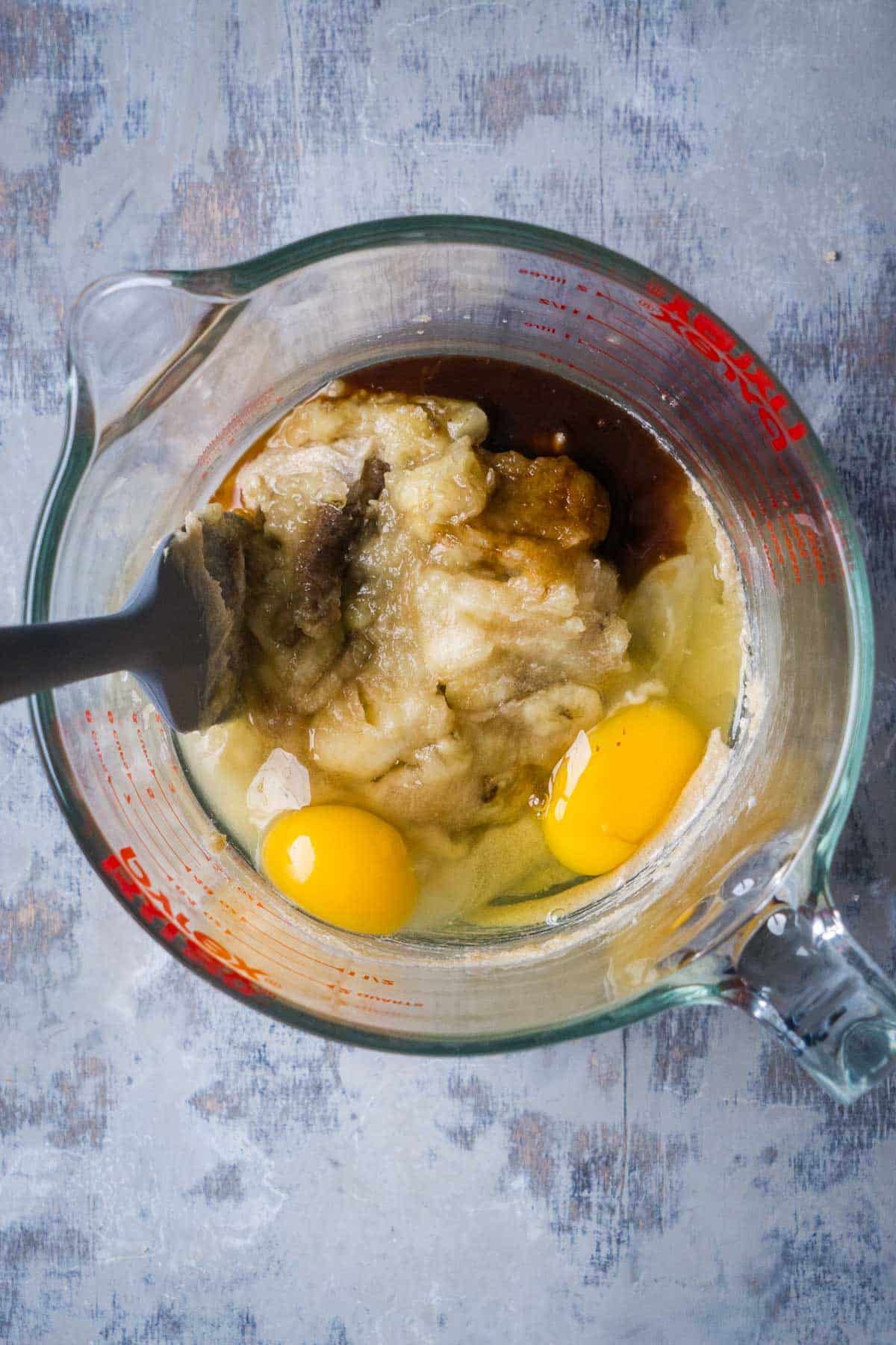 wet ingredients for chocolate banana bread in glass mixing bowl