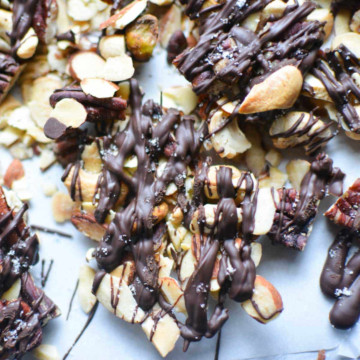 clusters of chocolate covered nuts on parchment paper