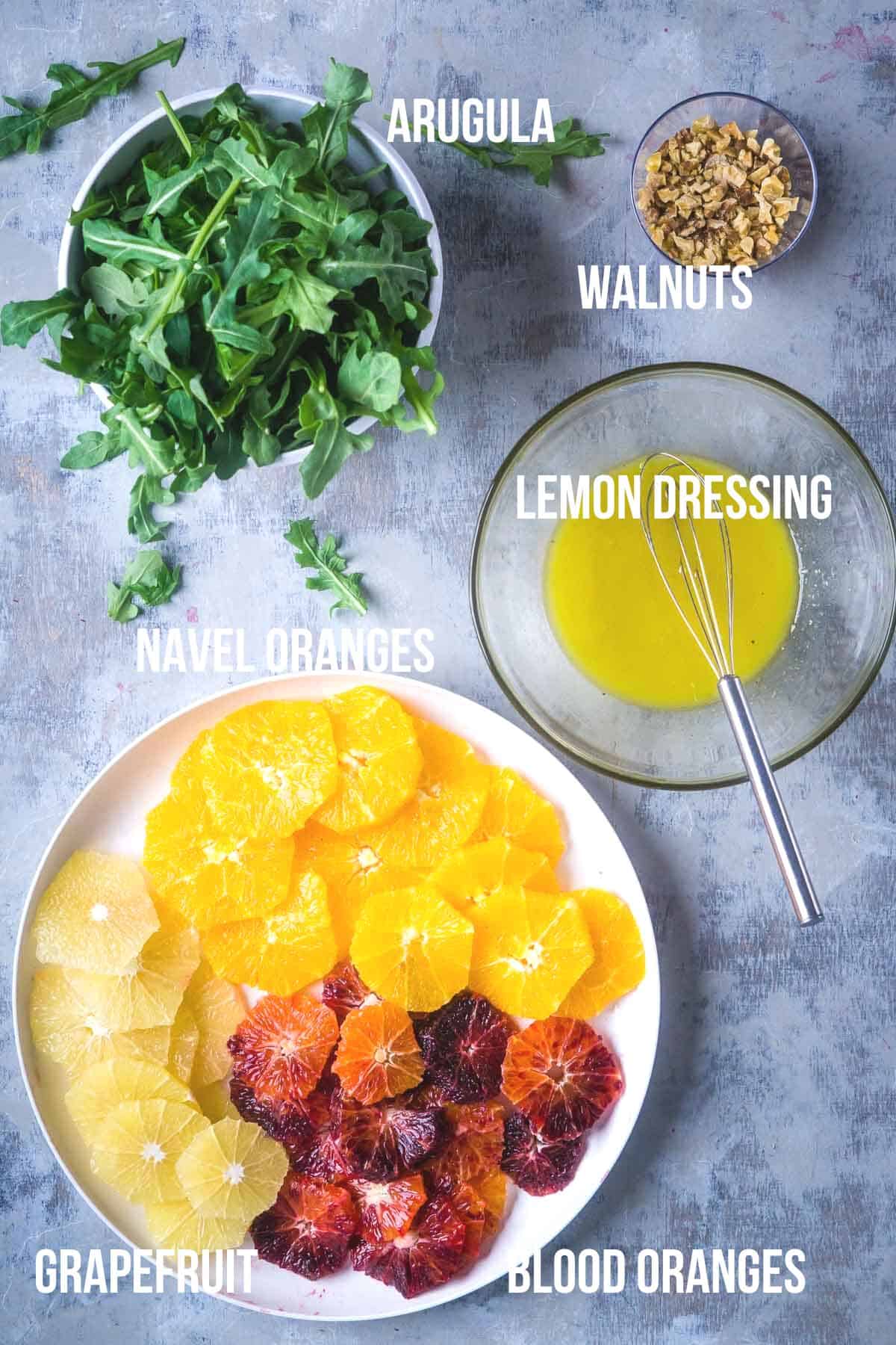 labeled citrus salad ingredients in bowls
