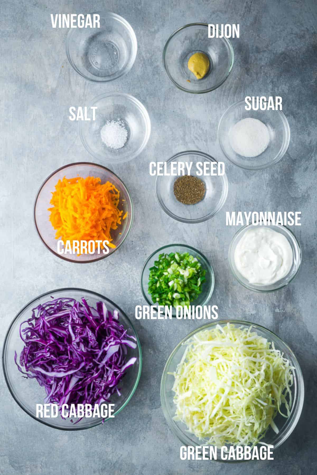 coleslaw recipe ingredients in glass bowls with labels