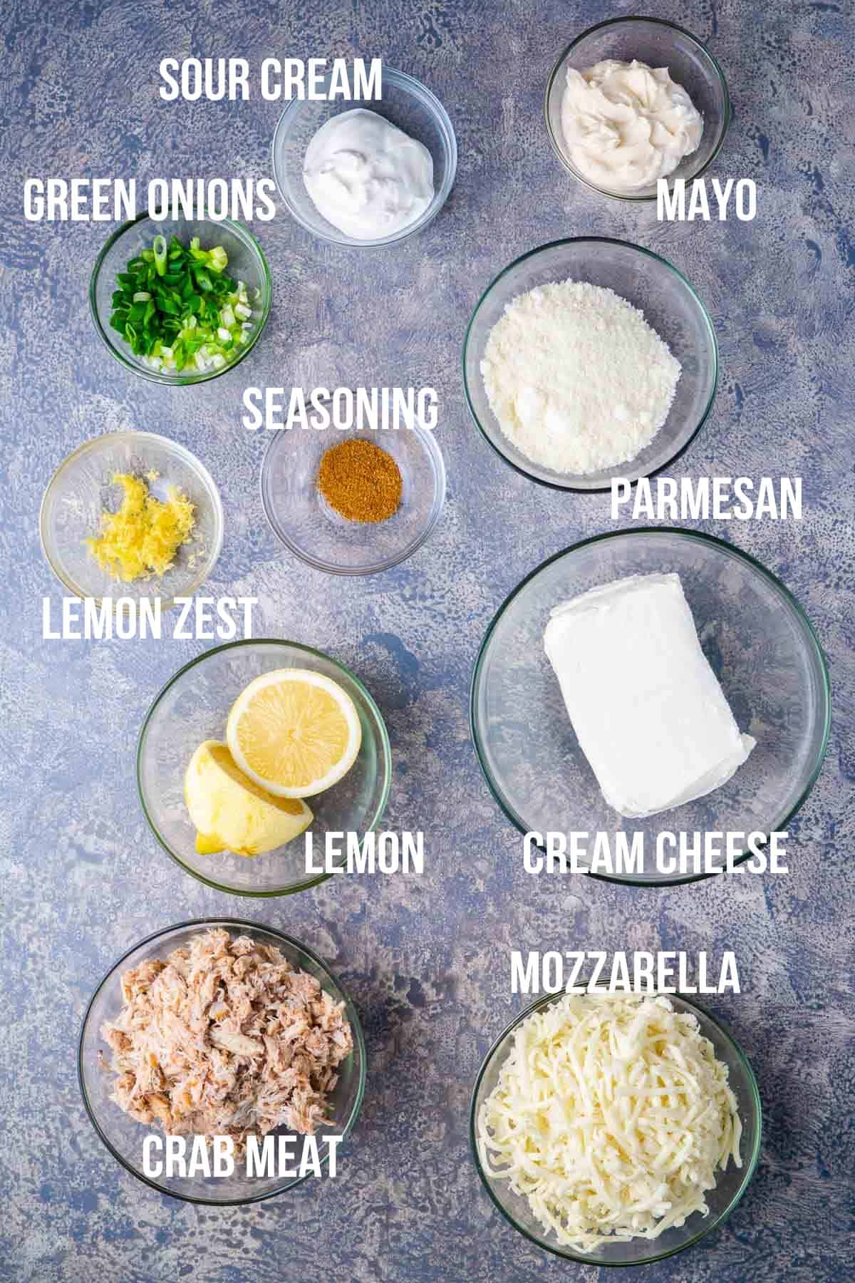 crab dip recipe ingredients labeled in glass bowls