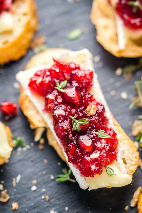 crostini with brie and cranberry sauce on tray