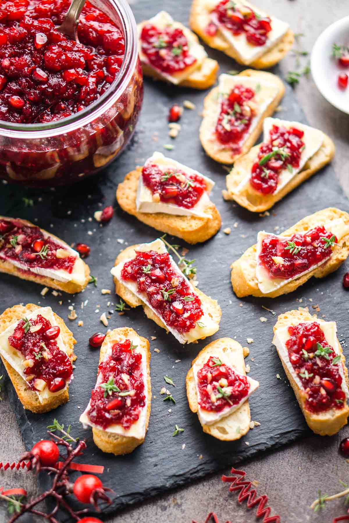 cranberry brie crostini appetizers on slate serving tile
