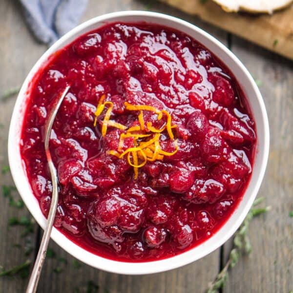 cranberry orange sauce in bowl with serving spoon