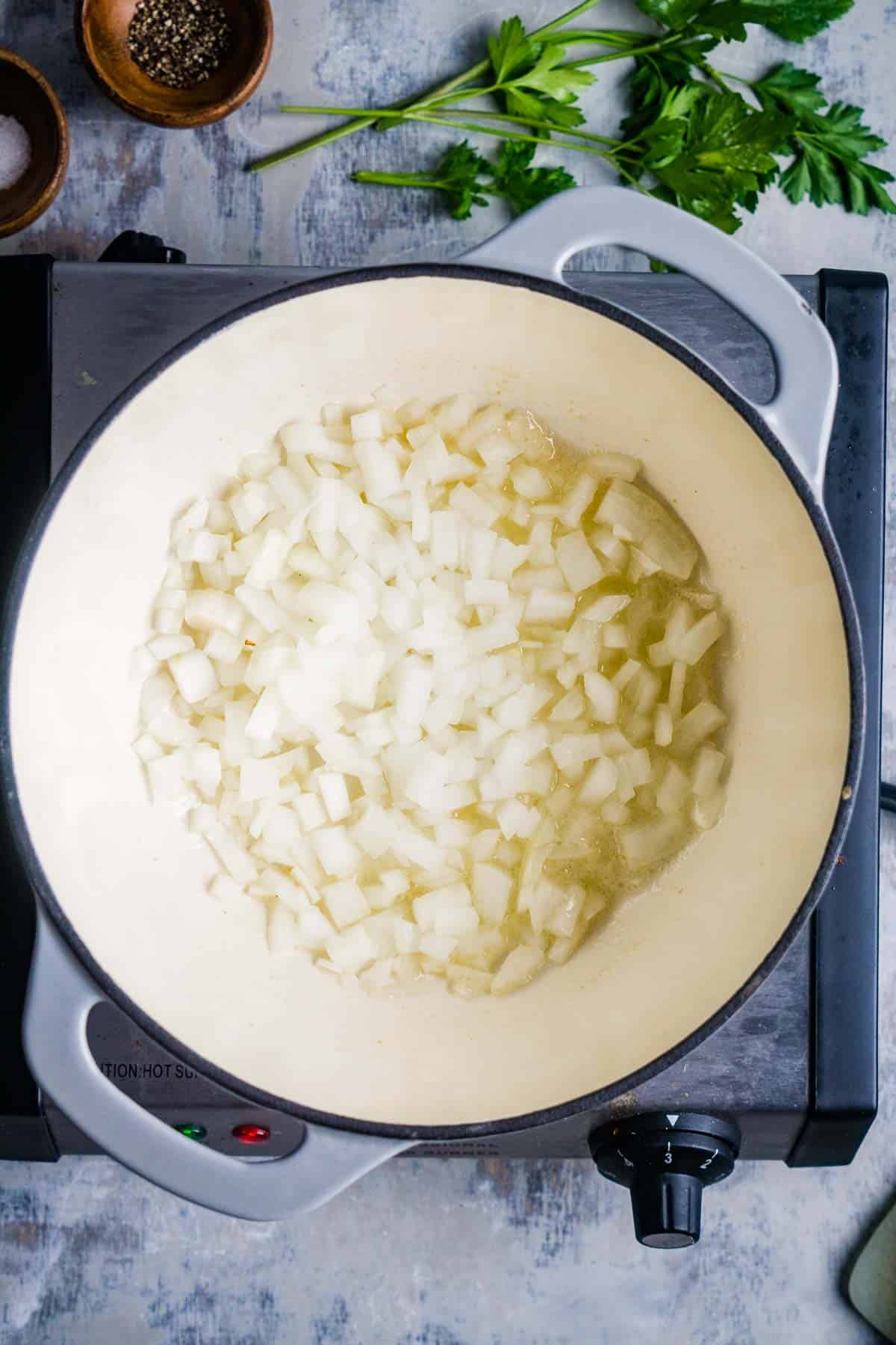 onions sauteing in butter in soup pot