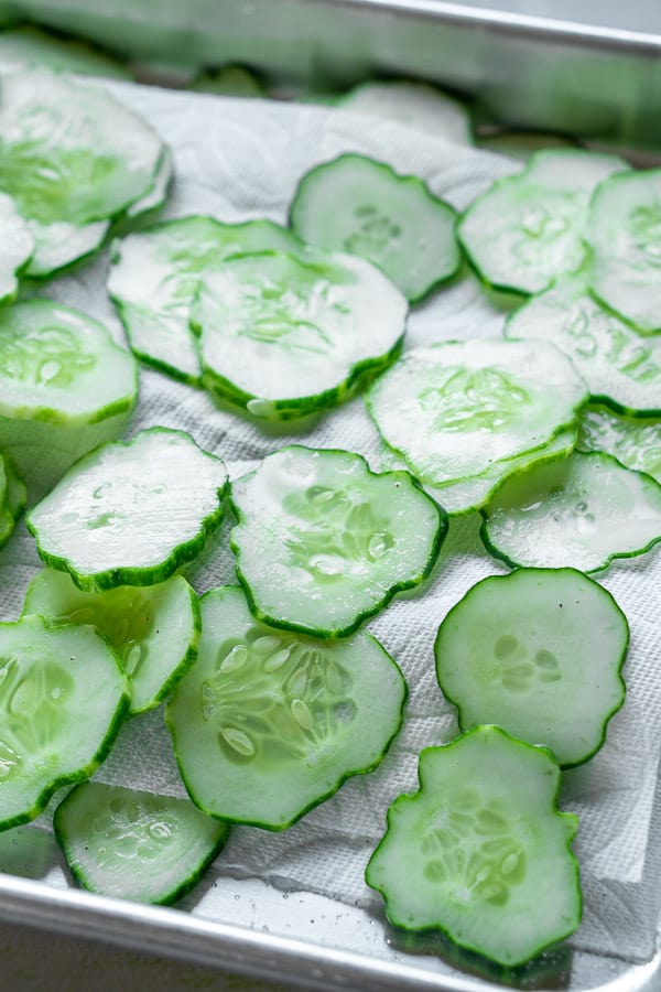 sliced cucumbers laying on paper towels
