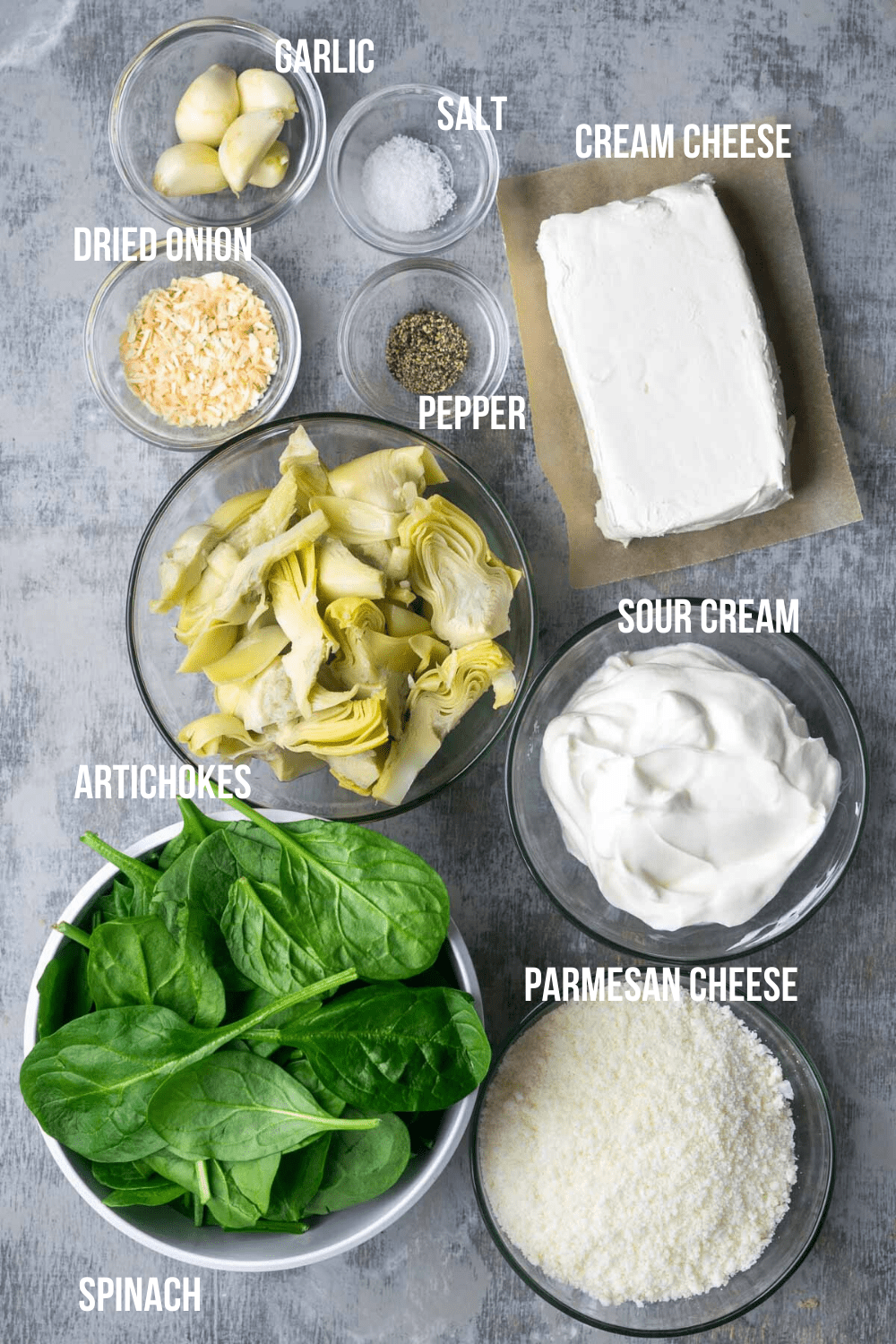 Overhead view of spinach artichoke dip ingredients with labels