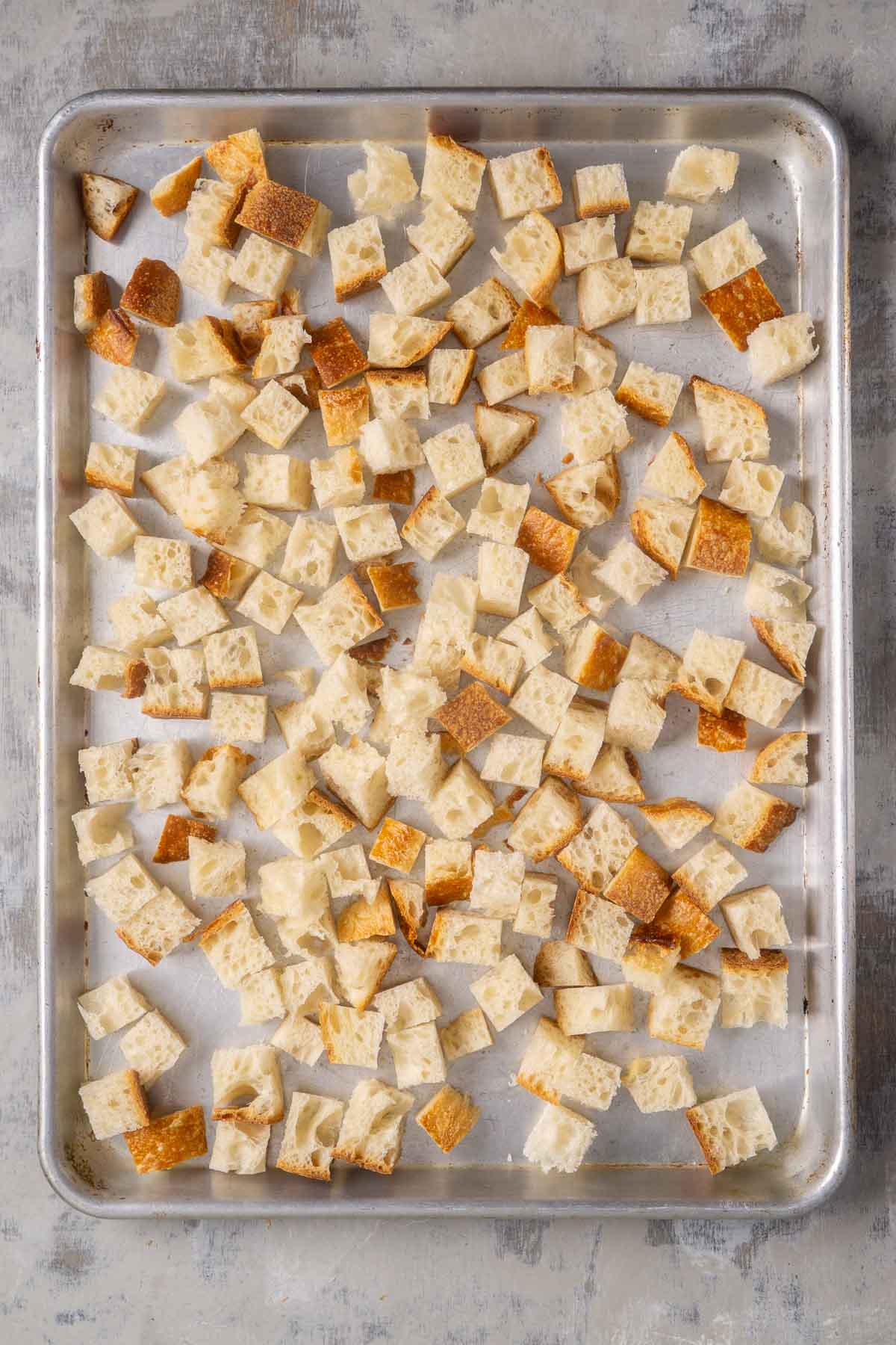 bread cubes on baking sheet