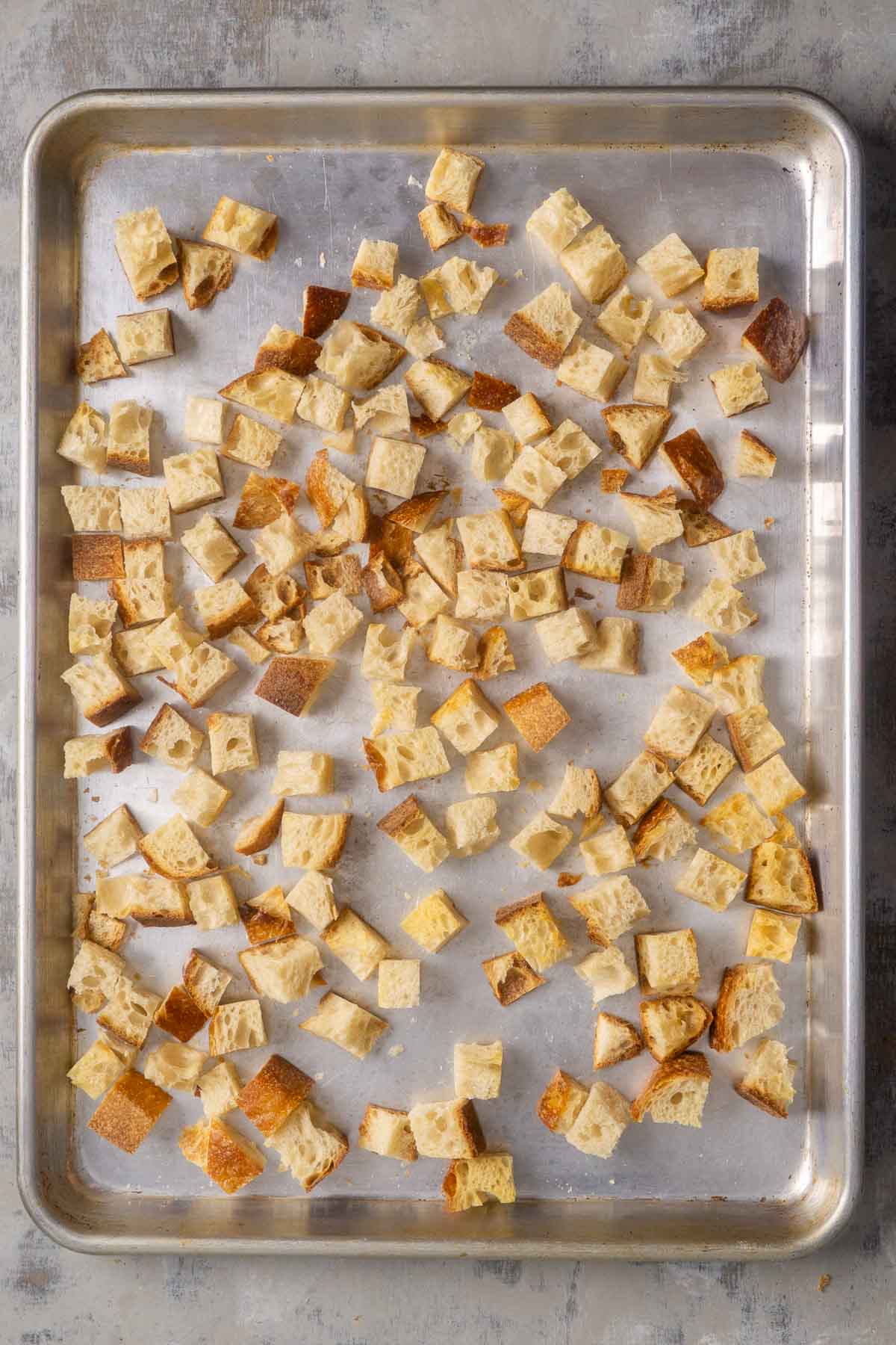 dried bread cubes on baking sheet