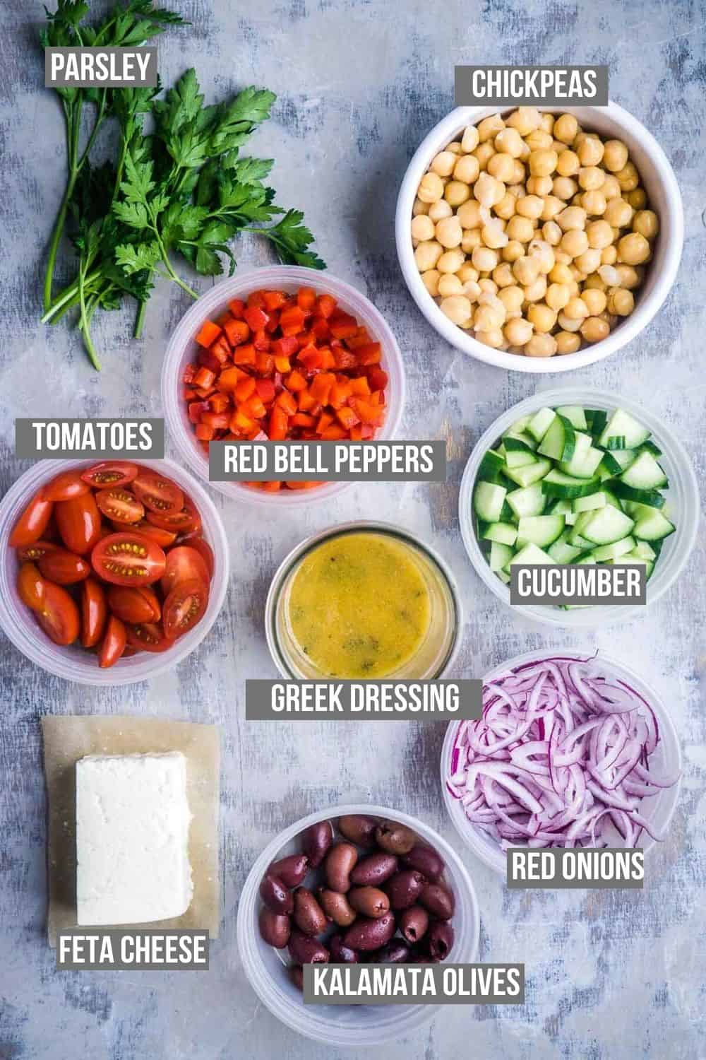 Greek chickpea salad ingredients measured into bowls and ready to use