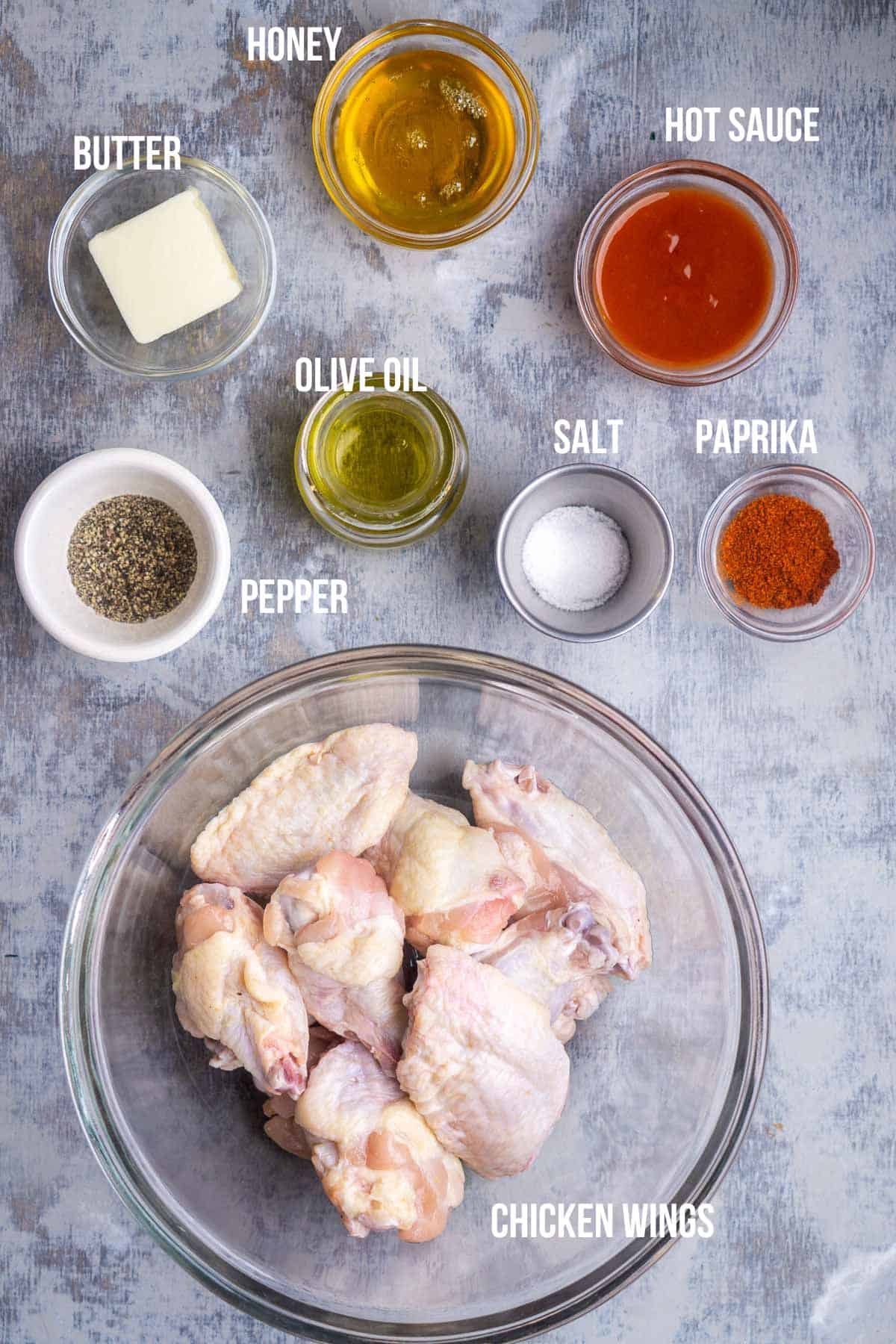 honey hot wings recipe ingredients in bowls labeled and ready to use