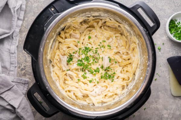 Instant pot chicken Alfredo in the Instant Pot garnished with chopped parsley