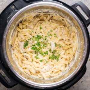 Instant pot chicken Alfredo in the Instant Pot garnished with chopped parsley